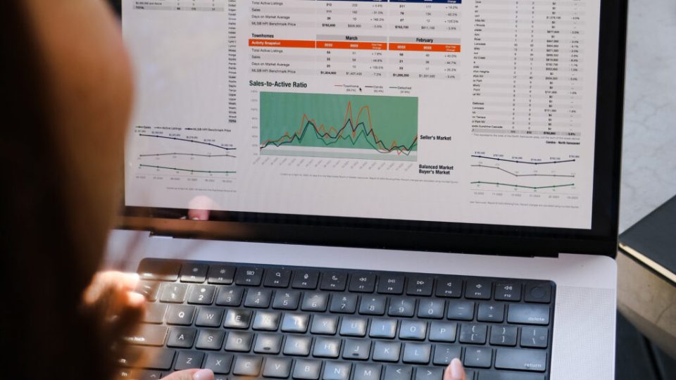 Vancouver Real Estate Market Update – July 2025 Market Stats on the laptop